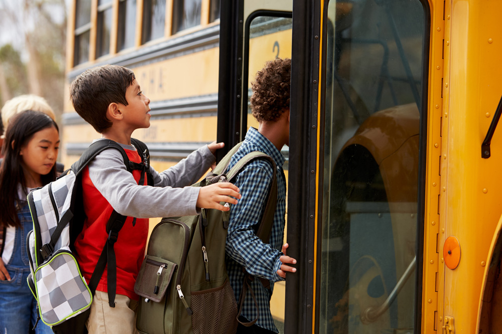 School children boarding the bus in West Haven Park, going to elementary school and junior high school West Haven Public School.